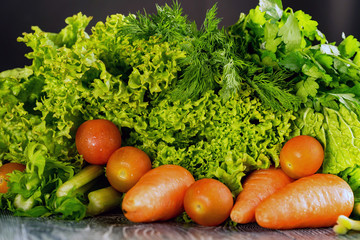 Raw carrot with various greens with copyspace