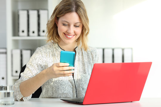 Businesswoman using multiple devices at office