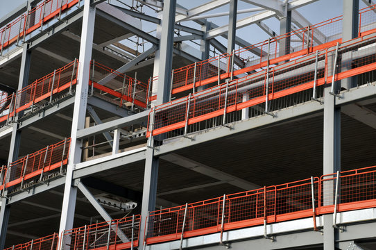 stell frame building on a modern construction site with orange safety rails and grey girders