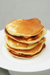 Fototapeta na wymiar A Stack of Sweet Pancakes on a White Background. Breakfast.