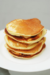A Stack of Sweet Pancakes on a White Background. Breakfast.