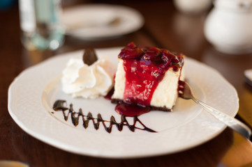 Cheese Cake with Souce adn Decoration on White Plate in Restaurant