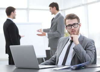 successful businessman sitting at Desk in office