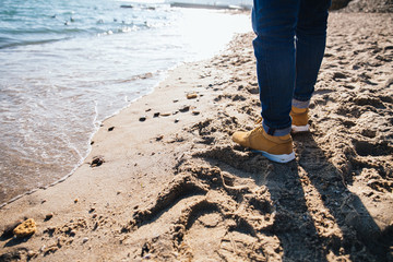 Man walking on the beach by the sea
