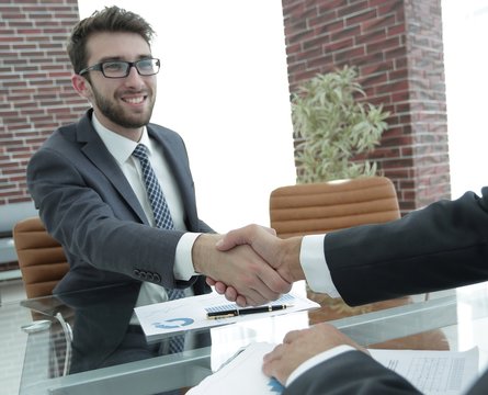 financial partners handshake after signing contract