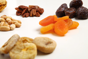 piles of Mixed dried fruits and nuts - symbols of jewish holiday Tu Bishvat