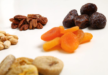 piles of Mixed dried fruits and nuts - symbols of jewish holiday Tu Bishvat