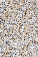 Variety of river pebbles wall. Texture with A lot of small round stones. Light Colored,Pattern of pebbles. Abstract Background Texture of many color brown, blue, white and black stones. Filled frame