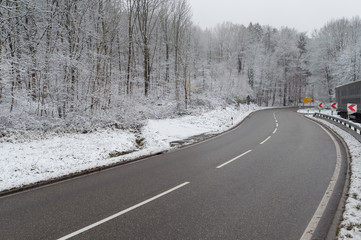 Empty road along forest in winter setting