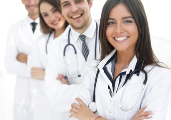 Fototapeta premium female doctor with group of happy successful colleagues