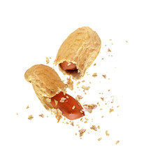 Dried peanut broken into two parts close up, isolated on white background