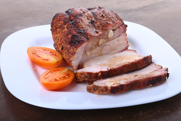 grilled pork chops with tomato and ketchup on plate.
