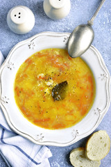 Pureed potato soup with chicken,millet, fried onion and carrot.Top view.