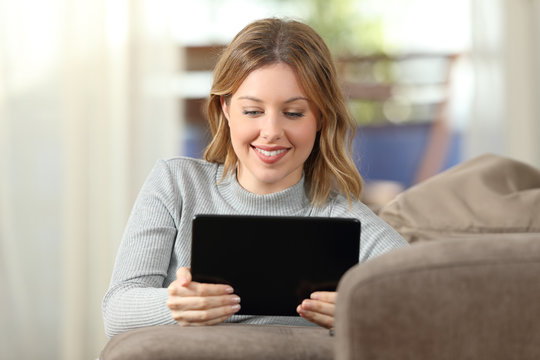 Woman watching video in a tablet at home