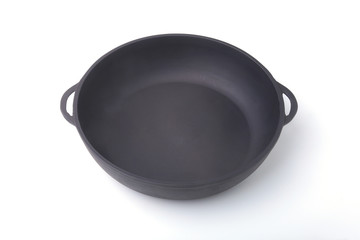 A new, clean and empty cast-iron pan for the grill.