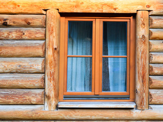 Obraz na płótnie Canvas wall with window of modern log house in village