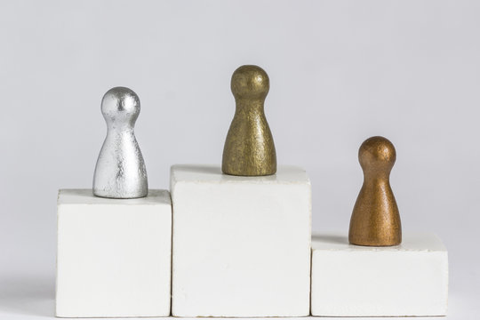 Playful Concepts: Gold, Silver and Bronze gamefigurine on a winner podium
