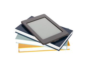Ebook reader with empty screen on top of paper books. Isolated on white.