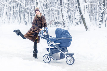 Woman dancing while winter walk with a stroller.