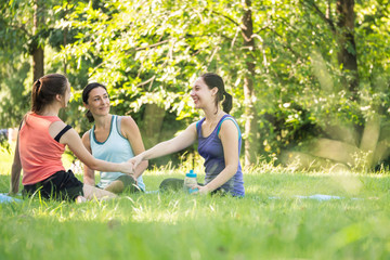 Fototapeta premium Activities in the family, mother and daughter relaxing in the park after practicing yoga.