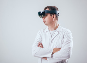 Doctor uses augmented reality goggles.