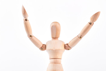 Wooden dummy raised hands over white. Wooden figure model mannequin isolated on white background with raised hands.