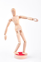Action of wooden human dummy. Yellow wooden dummy in action on white background.