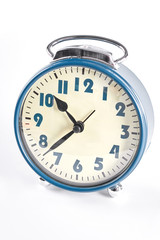 Old alarm clock on white background. Classic blue alarm clock isolated on white background.