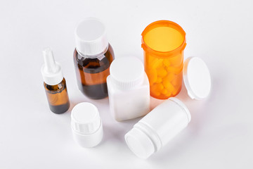 Nasal spray, cough syrup, pills. Set of medicament for cold treatment, white background. Medicine, health care and pharmaceutical drugs concept.