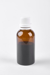 Bottle with cough syrup, white background. Medical liquid in glass brown bottle on white background, front view.