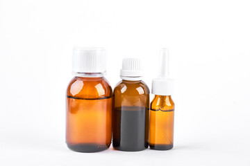 Composition of bottles with medical liquid. Three brown glass bottles with medicine isolated on...