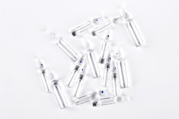 Medical ampoules with transparent liquid. Set of glass ampoules with medicine for injections on white background.