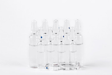 Group of glass break-seal ampules. Set of medical ampoules with liquid for injection, white background.