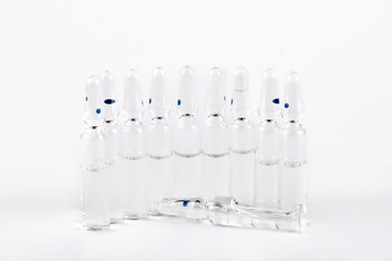 Set of medical ampoules with liquid. Glass ampules with medicine liquid for injection on white background.