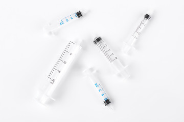 Set of syringes without needles. Group of plastic medical syringes without needles on white...