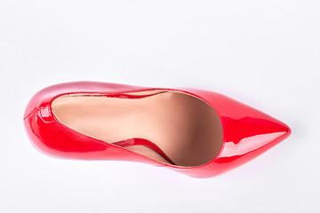 Female red shoe, top view. Woman lacquered shoe on high heel isolated on white background.