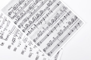 Musical notes on white background. Sheets with musical notes on white background. Music and...