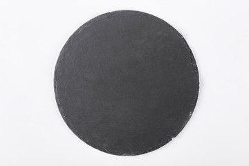Fototapeta na wymiar Slate stone tray, top view. Round slate stand isolated on white background.