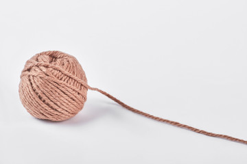 Ball of yarn on white background. Tangle of knitting brown yarn isolated on white background.