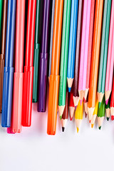 Palette of multicolored pencils for drawing. Variety of colorful pencils and markers on white background.
