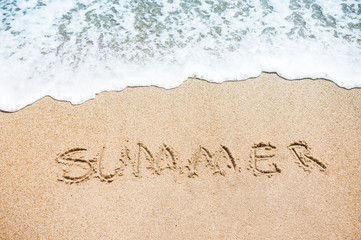 The Word Summer Written in the sand seashore.  Sea summer Background