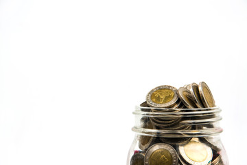 coin stacks in glass with tree on white background
