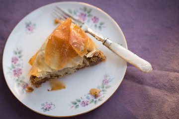Slice of M'Hencha cake on a plate