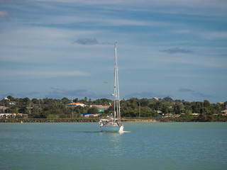 Sailboat by a tropical island in the Caribbean sea