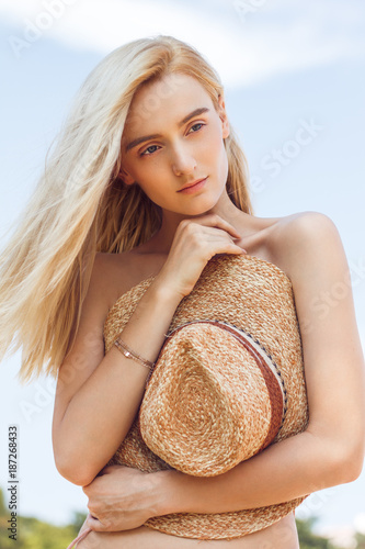 A Beautiful Young Woman With Long Blonde Hair On Beach Without Clothes Hides Behind A A Beautiful Young Woman With Long Blonde Hair On Beach Without Clothes Hides Behind A