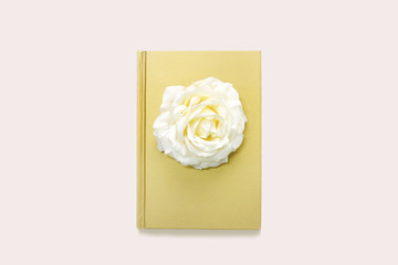 A beautiful gold book with flower on the white background