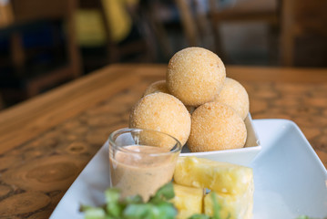 fried cheese balls on white plate