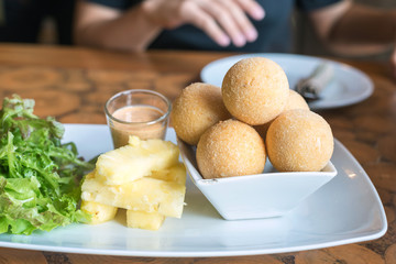 fried cheese balls on white plate