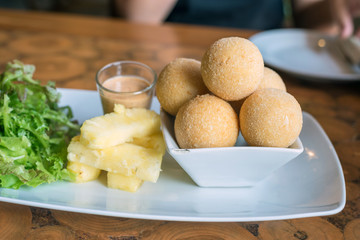 fried cheese balls on white plate
