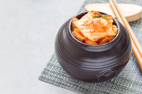 Kimchi cabbage. Korean appetizer in ceramic jar, horizontal, copy space